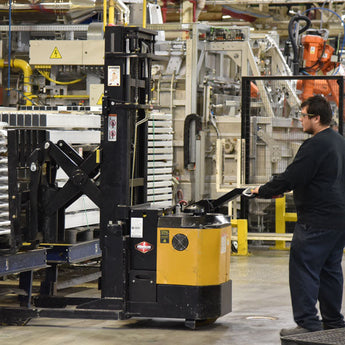 Warehouse worker uses Big Joe PDSR to stack pallet